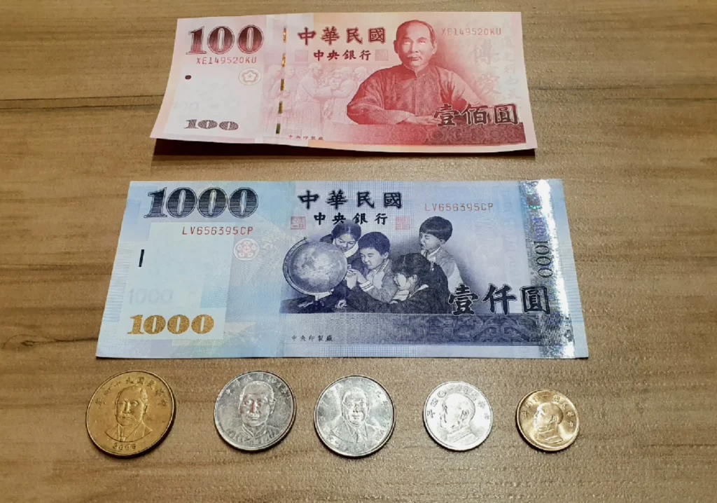 photo of New Taiwan Dollar 1000 and 100 banknotes and 50, 10, and 1 coins